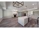 Open-concept living area featuring fireplace, spacious island, and contemporary lighting fixtures at 4531 Dry Run Rd, Fort Mill, SC 29708