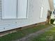 Exterior side view with white siding, brick foundation, and gravel driveway at 462 Dave Lyle Blvd, Rock Hill, SC 29730
