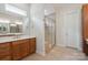 Bathroom with wood cabinets, white countertop, and walk-in shower at 467 Granite Lake Ct, Denver, NC 28037