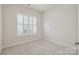 Bright, empty bedroom with a large window providing ample natural light, ready for personalization at 467 Granite Lake Ct, Denver, NC 28037