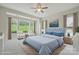 The primary bedroom features a blue bedspread and bright, natural light at 467 Granite Lake Ct, Denver, NC 28037