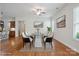 Bright dining room featuring modern glass table, stylish seating, hardwood floors, and contemporary decor at 467 Granite Lake Ct, Denver, NC 28037