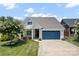 Charming single-story home featuring a blue garage door, well-maintained lawn, and beautiful landscaping at 467 Granite Lake Ct, Denver, NC 28037