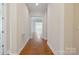 Long hallway featuring wood floors, leading to a sunlit room, creating a welcoming atmosphere at 467 Granite Lake Ct, Denver, NC 28037