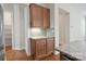 Detailed view of kitchen cabinetry and granite countertops, featuring undermount lighting and tiled backsplash at 467 Granite Lake Ct, Denver, NC 28037