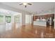 Bright living area featuring hardwood floors, flowing into the kitchen, and access to a screened porch at 467 Granite Lake Ct, Denver, NC 28037