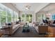 Bright living room with large windows, a ceiling fan, and a sliding glass door to the outdoor deck at 467 Granite Lake Ct, Denver, NC 28037