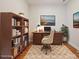 Cozy home office with a wooden desk, bookshelf, and a comfortable chair on a decorative rug at 467 Granite Lake Ct, Denver, NC 28037