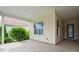 Covered patio showcasing neutral tiles, large windows, and a tranquil outdoor space with lush greenery at 467 Granite Lake Ct, Denver, NC 28037