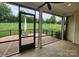 Inviting screened porch with serene views of the lush greenery and landscaped yard, ideal for relaxation at 467 Granite Lake Ct, Denver, NC 28037