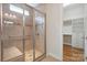 Walk-in shower with glass door, bench seat, and convenient grab bar at 467 Granite Lake Ct, Denver, NC 28037