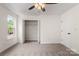 Bright bedroom with a ceiling fan, closet, and window letting in natural light at 5529 Seths Dr, Charlotte, NC 28269