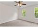 Bedroom featuring neutral carpet, ceiling fan, and two windows allowing natural light at 5529 Seths Dr, Charlotte, NC 28269