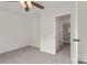Bright bedroom with neutral carpet, a ceiling fan, and an open doorway to a hall at 5529 Seths Dr, Charlotte, NC 28269