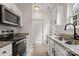View of an updated kitchen with stainless steel appliances and stone countertops at 5529 Seths Dr, Charlotte, NC 28269