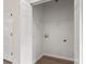 Bright laundry room featuring white walls, hookups, and a wire shelf for organization at 5529 Seths Dr, Charlotte, NC 28269