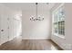 Open-concept living room with modern lighting, hardwood floors, and a large window at 5529 Seths Dr, Charlotte, NC 28269