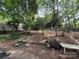 Private backyard with mature trees and space for outdoor recreation at 616 E Oakwood Ave, Albemarle, NC 28001