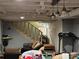A finished basement with stairs, a couch, and hanging lights at 616 E Oakwood Ave, Albemarle, NC 28001