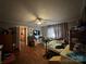 This bedroom has hardwood floors, a ceiling fan, and windows with curtains at 616 E Oakwood Ave, Albemarle, NC 28001