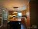 Kitchen with a central island, wood cabinets and modern lighting fixtures at 616 E Oakwood Ave, Albemarle, NC 28001