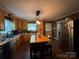 Well-lit kitchen with stainless steel appliances, tile floor and wood cabinets at 616 E Oakwood Ave, Albemarle, NC 28001