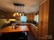 Bright kitchen featuring wooden cabinets, an island and a modern lighting fixture at 616 E Oakwood Ave, Albemarle, NC 28001