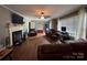 Cozy living room with fireplace, hardwood floors, and neutral walls at 616 E Oakwood Ave, Albemarle, NC 28001