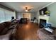 Spacious living room with hardwood floors, fireplace, and abundant natural light at 616 E Oakwood Ave, Albemarle, NC 28001