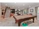 Finished basement with billiards table, stairs, and view of fireplace in background at 625 Saint Andrews Rd, Statesville, NC 28625