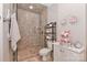 Bathroom with tile shower, tiled floor, and charming decor at 625 Saint Andrews Rd, Statesville, NC 28625