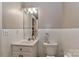 Cozy bathroom with white tile, single vanity, and ample lighting at 625 Saint Andrews Rd, Statesville, NC 28625