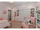 Cozy bedroom with closet and shelving, soft pink armchair, and neutral carpeting at 625 Saint Andrews Rd, Statesville, NC 28625
