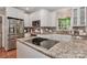 Open kitchen featuring an island with cooktop, stainless steel appliances, and granite countertops at 625 Saint Andrews Rd, Statesville, NC 28625