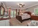 Spacious main bedroom with dark wood furniture, plush carpet, balcony doors, and elegant decor at 625 Saint Andrews Rd, Statesville, NC 28625
