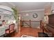 Open upstairs landing featuring hardwood floors, a desk area, and a piano at 625 Saint Andrews Rd, Statesville, NC 28625