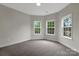 A bright and airy bedroom with a neutral color scheme and large windows providing natural light at 6718 Heritage Orchard Way, Huntersville, NC 28078