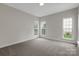 Bright bedroom with natural light and neutral carpet ready for your personal touch at 6718 Heritage Orchard Way, Huntersville, NC 28078