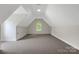 A spacious bonus room on the third floor, offering a versatile space with neutral carpeting and ample light at 6718 Heritage Orchard Way, Huntersville, NC 28078