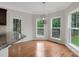 Bright breakfast nook with hardwood floors, modern lighting, and views of the outdoor deck at 6718 Heritage Orchard Way, Huntersville, NC 28078