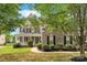 Charming two-story brick home featuring a welcoming front porch and well-manicured landscaping at 6718 Heritage Orchard Way, Huntersville, NC 28078