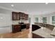 A modern kitchen boasts granite countertops, stainless steel appliances and dark wood cabinetry at 6718 Heritage Orchard Way, Huntersville, NC 28078
