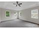 Spacious main bedroom featuring a tray ceiling, neutral walls, and large windows for natural light at 6718 Heritage Orchard Way, Huntersville, NC 28078