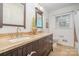 Bathroom featuring double sink vanity with stone countertop, stylish fixtures, and tiled floor at 6749 Windyrush Rd, Charlotte, NC 28226
