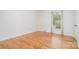 Bright bedroom with hardwood floors, white walls, and a window with natural light at 6749 Windyrush Rd, Charlotte, NC 28226