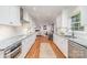 Bright, remodeled kitchen with white cabinets, granite countertops, and stainless steel appliances, flowing into the living area at 6749 Windyrush Rd, Charlotte, NC 28226