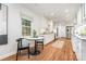 Sunlit kitchen featuring white cabinetry, stainless steel appliances, granite countertops, and a breakfast nook area at 6749 Windyrush Rd, Charlotte, NC 28226