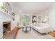 Bright living area with a brick fireplace, neutral décor, and ample natural light from surrounding windows at 6749 Windyrush Rd, Charlotte, NC 28226