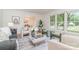 Bright living room featuring hardwood floors, a large window, and stylish furniture at 6749 Windyrush Rd, Charlotte, NC 28226