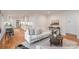 Comfortable living space showcasing white furniture, hardwood floors, and an open layout to the kitchen at 6749 Windyrush Rd, Charlotte, NC 28226
